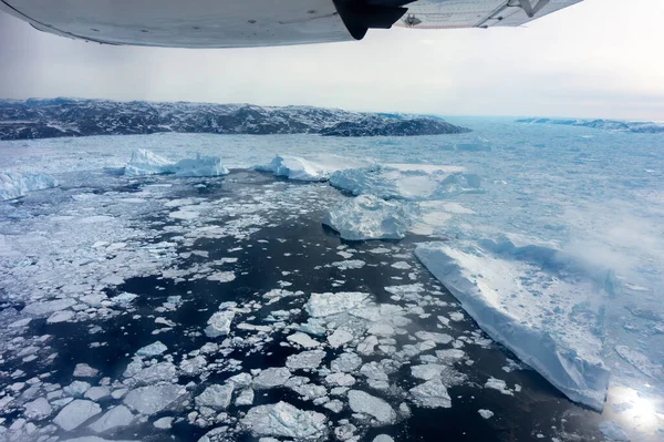 在格陵兰岛上空飞行 冰山漂浮在海面上 — 图库照片