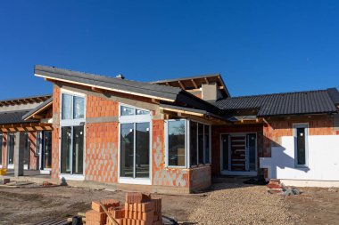 modern House under construction with polystyrene insulation and bricks .