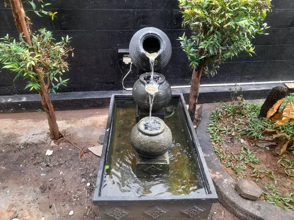 fountain design from a jar in the yard of the house. home interior background concept, decoration, exterior, view, landscape, nature, natural, garden, gardening, farm, farming, lifestyle,park, outdoor