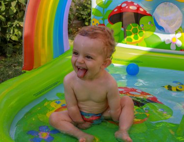 the joy of my one year old son while having a bath in fresh water