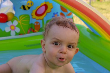 my son loves having a bath in a plastic pool in his grandparents garden