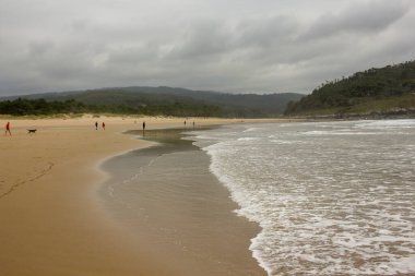 cold and long beach in Spain in a cloudy day