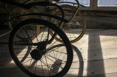 the shadows of my baby stroller in the attic during sunset