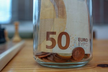 euros from last month tips in a glass jar