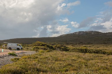 Doğanın ortasına park edilmiş bir minibüs, Batı Avustralya 'nın güneyinde vahşi dağlar - Avustralya vanLife - Cape le Grand, Esperance WA, Avustralya