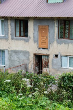 Typical house with antique vehicle in the city of Mestia in Geogia, 