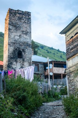 Svan tower next to the typical houses of Adishi village. The Mestia-Ushguli trek, Georgia. 