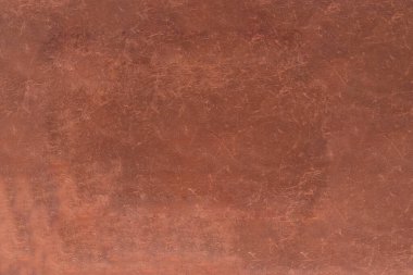 Eski ve çizik deri dokusuna sahip soyut bir arkaplan.