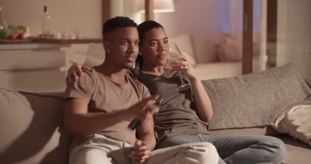 Diversa pareja viendo la televisión durante la fecha — Vídeo de stock