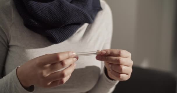 Mixed race female checking temperature — Vídeos de Stock