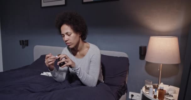 African American woman taking medication — Stock Video