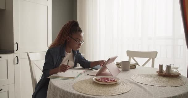Young African American Woman Browsing Data Tablet Making Notes — Stock Video