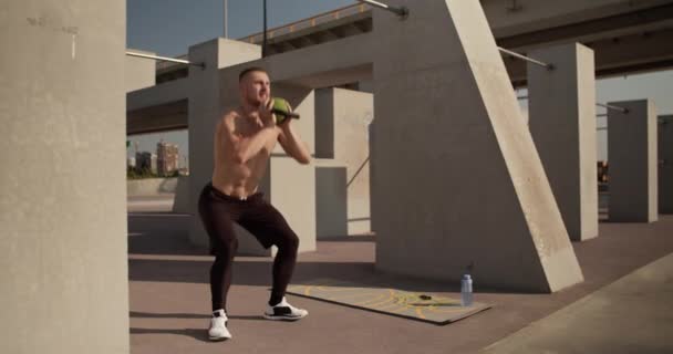 Muscular Male Athlete Doing Kettlebell Goblet Squats City Street — Wideo stockowe