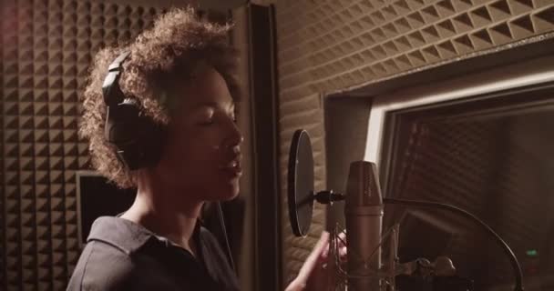 Black Signer Touching Headphones Performing Recording Studio — Stok video