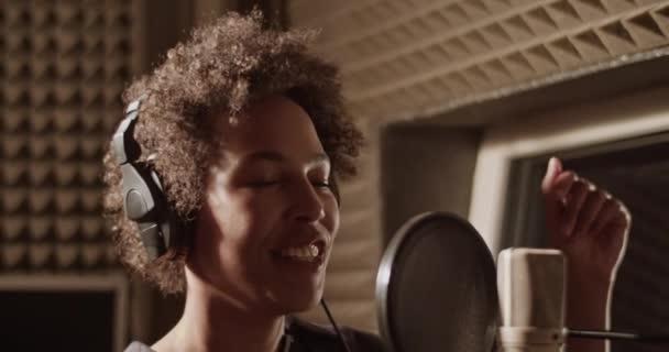 Black Singer Closed Eyes Recording New Song Soundproof Room — Vídeo de Stock