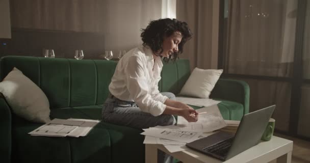 Adult Female Architect Making Notes Drafts While Sitting Sofa Table — Stockvideo