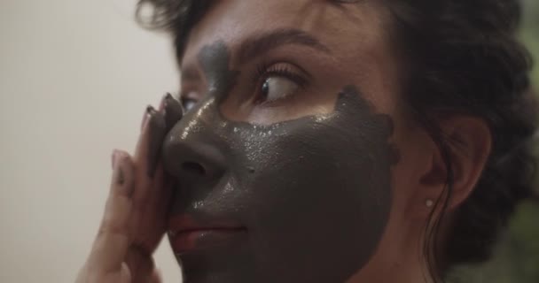 Adult Woman Dark Hair Smearing Clay Face Looking Away Beauty — Αρχείο Βίντεο