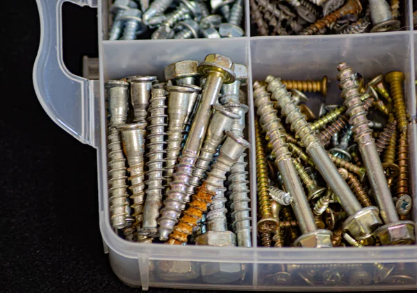 Many self-tapping screws stacked in sections in boxes — Stock Photo, Image