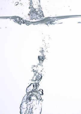 An abstract background created by air bubbles in water under white lighting.