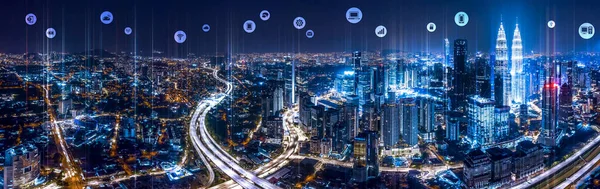 Panorama aerial view of Kuala Lumpur City center at night dusk with wireless communication network, abstract image visual, internet of things