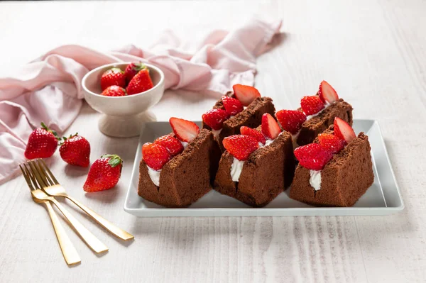 Chocolate chiffon cake with strawberries and whipped cream
