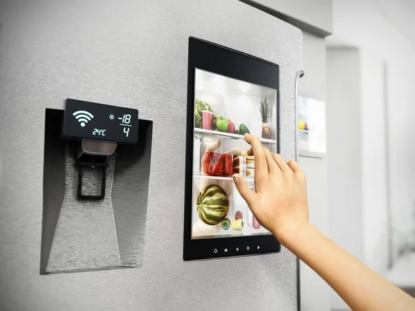 Hand controls smart refrigerator interface with an image of the interior.