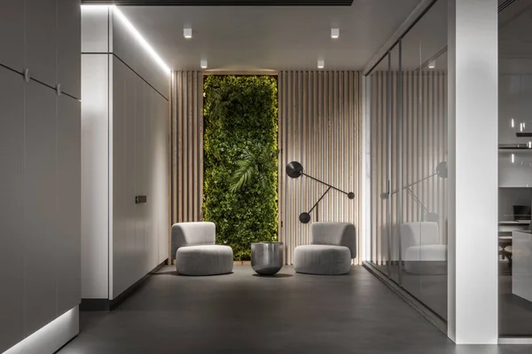 Creative office lobby with two chairs, center table, and plants on wooden wall. 3d rendering of modern office interior.