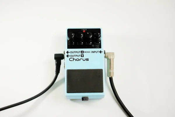 pedal effect guitar with plugged cable on white background