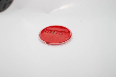 Red clothing sewing needle case on a white background 