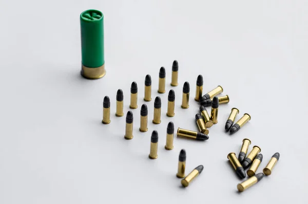 High angle view of bullets and shotgun shell on white background — Stock Photo