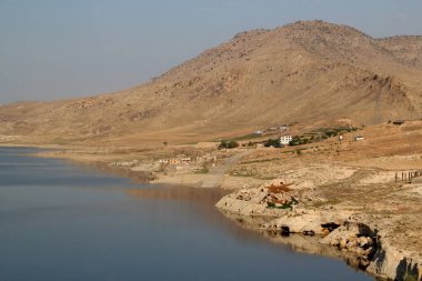 The reflection of the mountains in the Tigris River in the city of Hasankeyf in the Southeast Anatolia region of Turkey