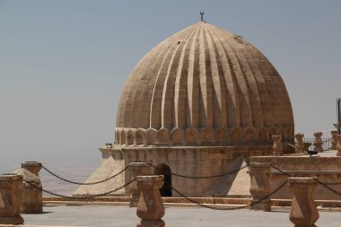 Mardin, Turkey - 08.25.2021: View of the large dome of Zinciriye Medresesi in the Southeast Anatolia region of Turkey