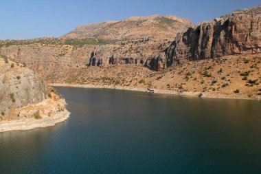 Landscape with mountains and smooth surface of Euphrates River near Nissibi Bridge in Southeast Anatolia region of Turkey