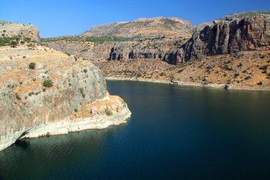 Landscape with mountains and smooth surface of Euphrates River near Nissibi Bridge in Southeast Anatolia region of Turkey