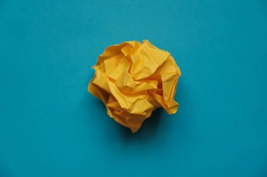 a ball of crumpled colored paper in the form of a rose