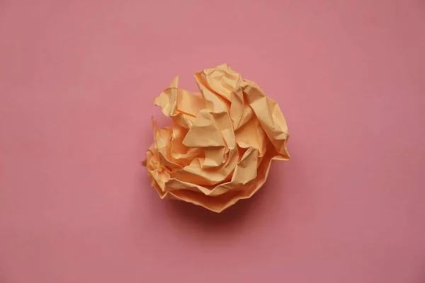 a ball of crumpled colored paper in the form of a rose