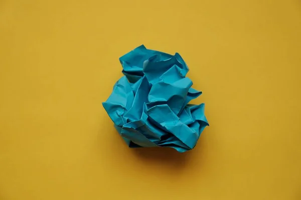 a ball of crumpled colored paper in the form of a rose