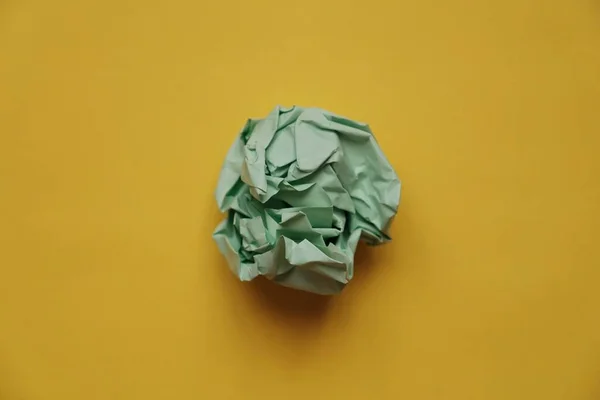 a ball of crumpled colored paper in the form of a rose