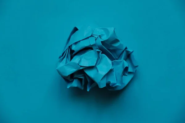 a ball of crumpled colored paper in the form of a rose