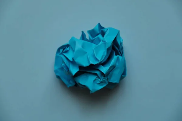 a ball of crumpled colored paper in the form of a rose