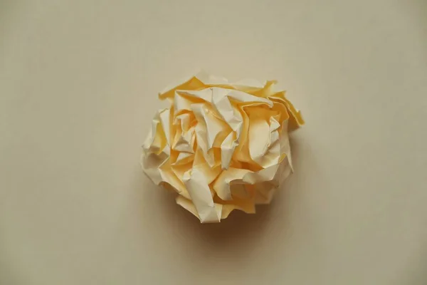a ball of crumpled colored paper in the form of a rose