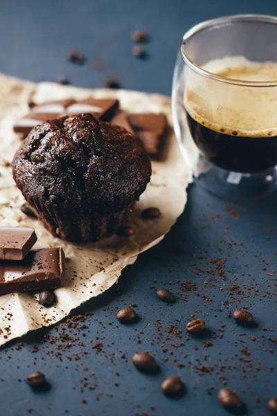 Coffee, muffin, chocolate on paper kraft on plaster background