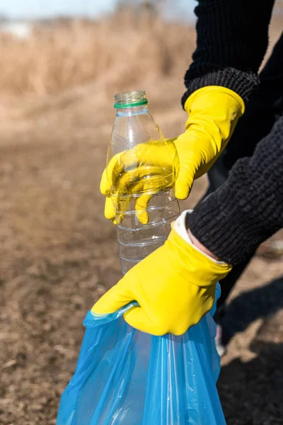 Guantes Amarillos Las Manos Activistas Naturaleza Sostienen Botella Plástico Vacía —  Fotos de Stock