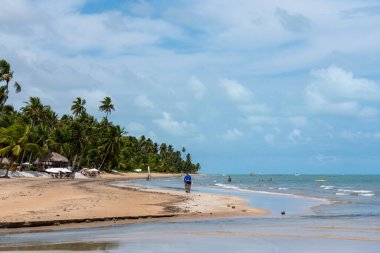 Brazil, Alagoas, 2021, january 21st -A long beach with tourists enjoying a summer day in northeast Brazil