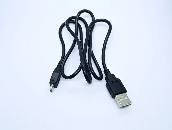 Black micro USB cable, isolated on the gray white background. Cable connector micro-USB to USB.