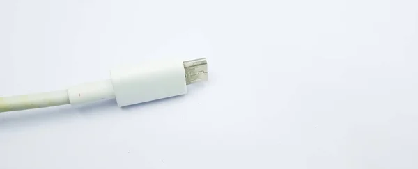 The old white micro USB cable plug, negative space, isolated on the gray white background. Close up white micro USB cable plug. Micro USB type B or USB-B plugs.