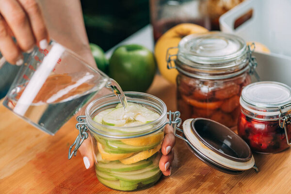 Fermentation food at home. Woman preparing fruits for fermentation.
