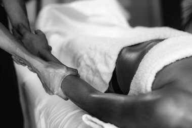 Ayurveda terapisti ruhani yağla kol masajı yapıyor.