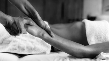 Ayurveda terapisti ruhani yağla kol masajı yapıyor.