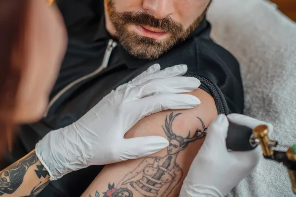 Tattooing process in a tattoo studio